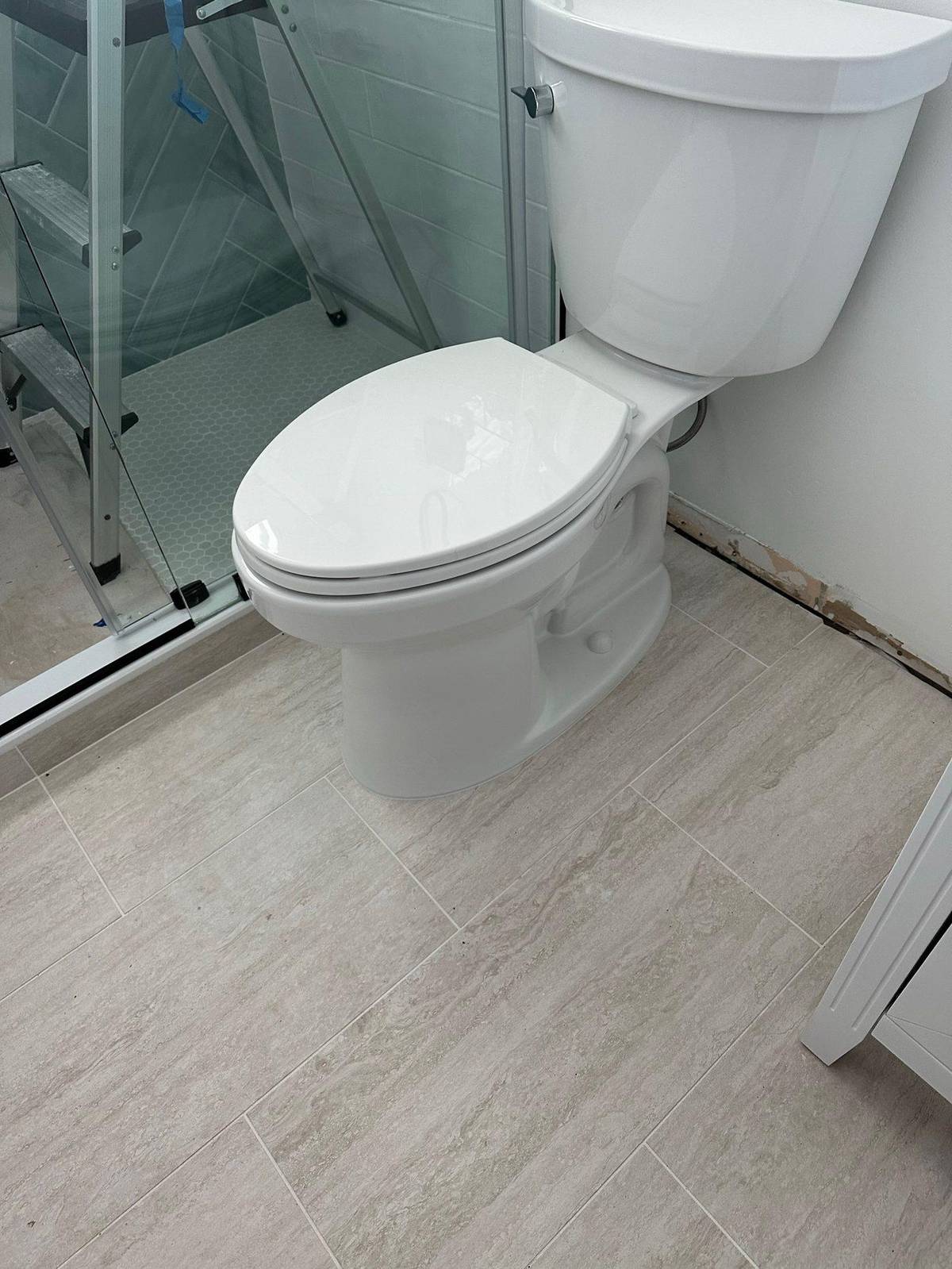 Plumber installing a new toilet in a Palm City, FL home